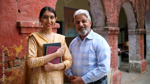 Two government school Indian teachers dressed decently posing for the camera - professors  lecturer . Newly appointed female assistant professor posing happily with her father - proud dad  school  ... photo