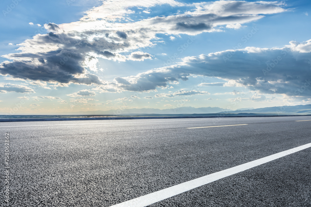 Asphalt highway and mountain with sky clouds background Asphalt highway and mountain with sky clouds background