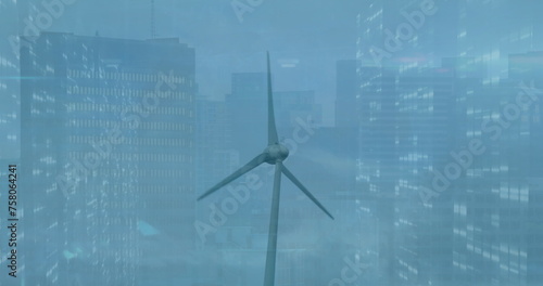 Image of trading board with graph over spinning windmill against buildings
