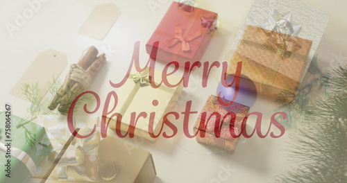 Image of christmas greetings text over christmas presents and decorations