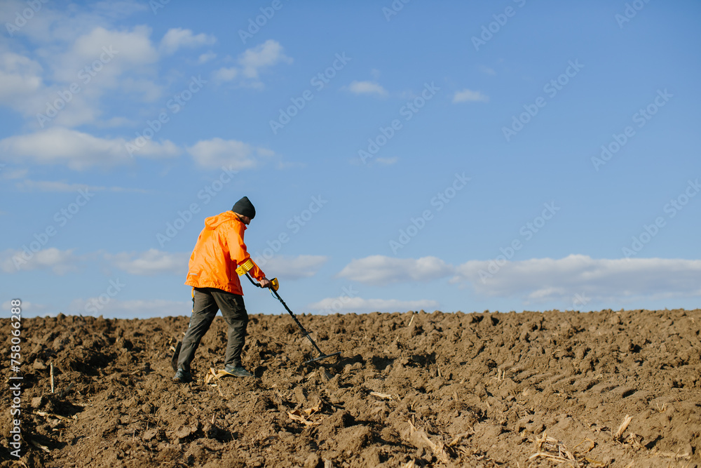 A man with an electronic metal detector in the field. Copyspace A man with an electronic metal detector in the field. Copyspace