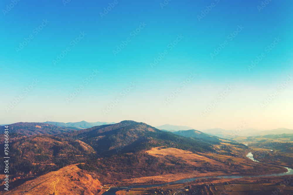 Top view of colorful mountain slopes and river Stryi on a sunny autumn day. Beautiful landscape. Carpathians, Carpathian Ruthenia, Ukraine