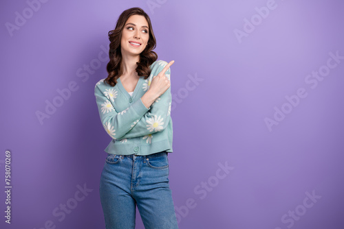 Photo of young smiling interested lady dressed glamour cardigan direct finger shopping mall opening isolated on violet color background