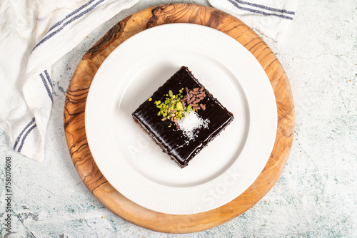 Moist chocolate cake dessert. Slice of milk and chocolate cake on wooden serving board. local name islak kek photo