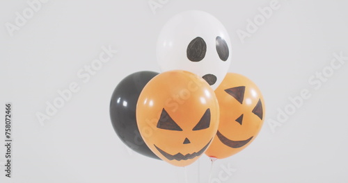 Image of happy halloween text over neon witch and orange and black balloons