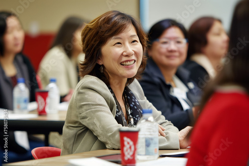 Cheerful Asian woman actively participates in a professional business seminar