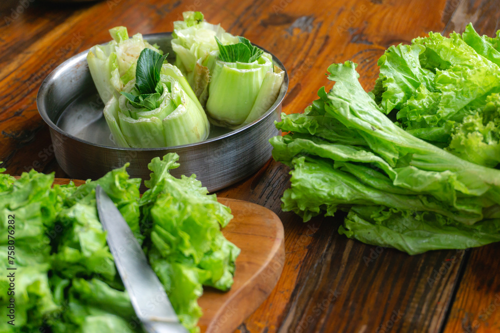 regrow lettuce by putting lettuce head on a bowl fill with water, concept of growing your food and zero waste regrow lettuce by putting lettuce head on a bowl fill with water, concept of growing your food and zero waste