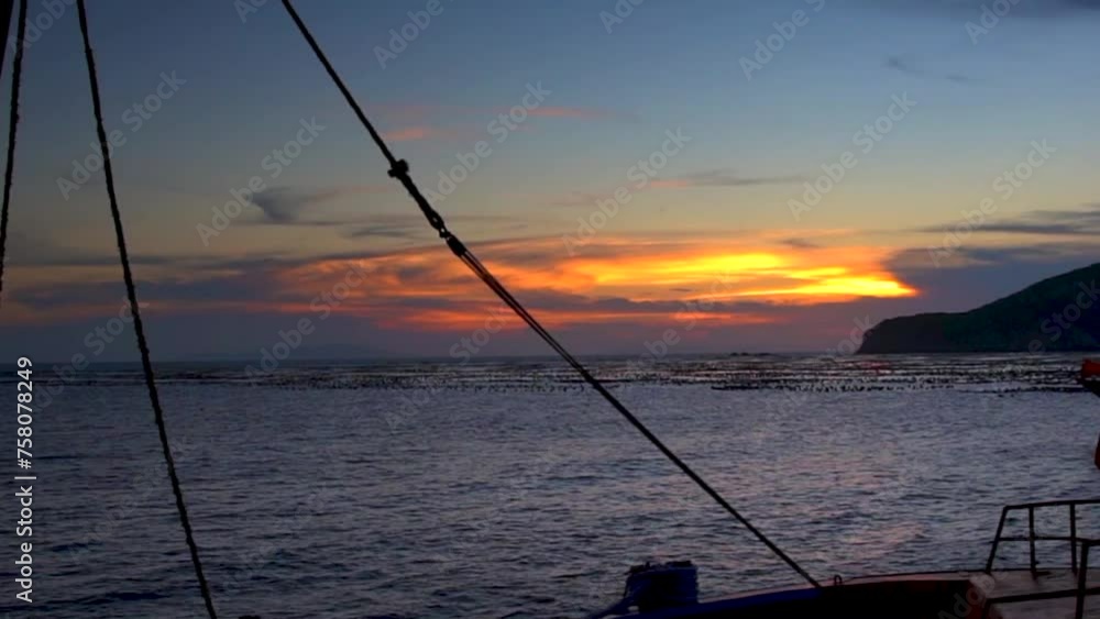 Sunset on fishing boat in the distance Sunset on fishing boat in the distance