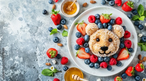 Adorable tiger pancake breakfast for kids with berries and honey on white plate, copy space