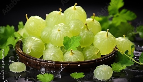 Amla berries with splashes and water drops on dark background