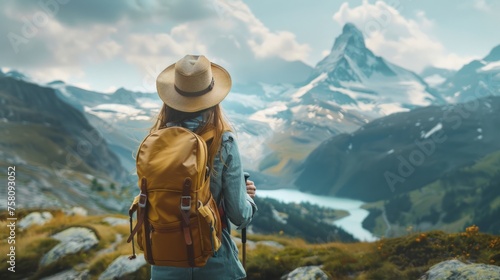Wanderlust adventure: woman with backpack gazing at majestic mountains and forests - travel concept image with copy space