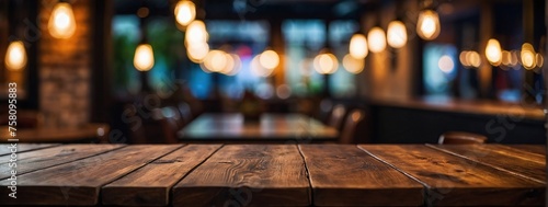 Empty wooden table top with lights bokeh on blur restaurant background © SR Production