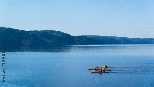 Saint-Rose-du-Nord, Canada - August 14 2019: People kayaking in Petit Saguenay valley view from Sainte-Rose-du-Nord