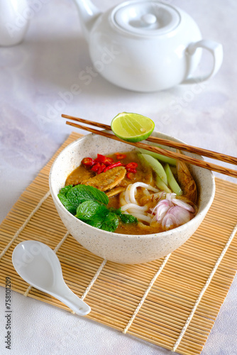 laksa ikan, asam laksa, rice noodle,vegetables, filet fish with sour soup, popular in penang, malaysia