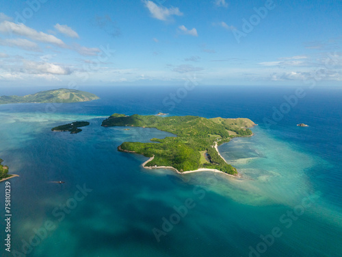 Cabangajan Island with white sand beach and turquoise sea water with corals. Santa Fe, Tablas, Romblon. Philippines.