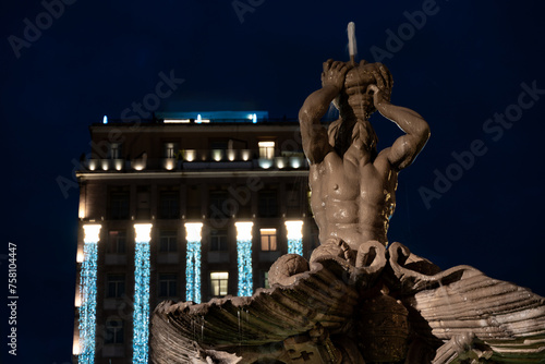 night scene of triton fountain in piazza barberini in rome