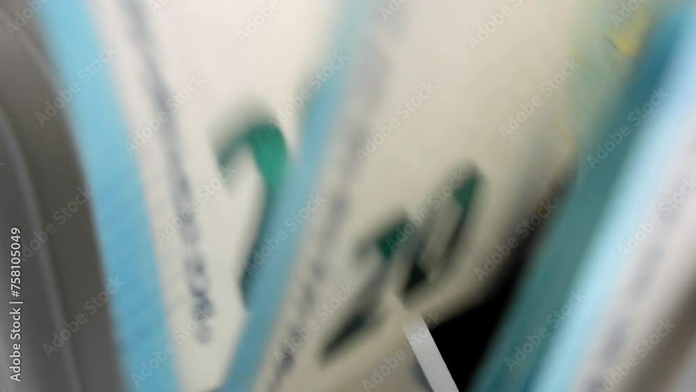 Close-up of 20 euro banknotes counted macro top view slow motion. Bank automatic equipment for counting cash money. European union currency. Inflation, economy, investment, income. Euro banknotes Close-up of 20 euro banknotes counted macro top view slow motion. Bank automatic equipment for counting cash money. European union currency. Inflation, economy, investment, income. Euro banknotes