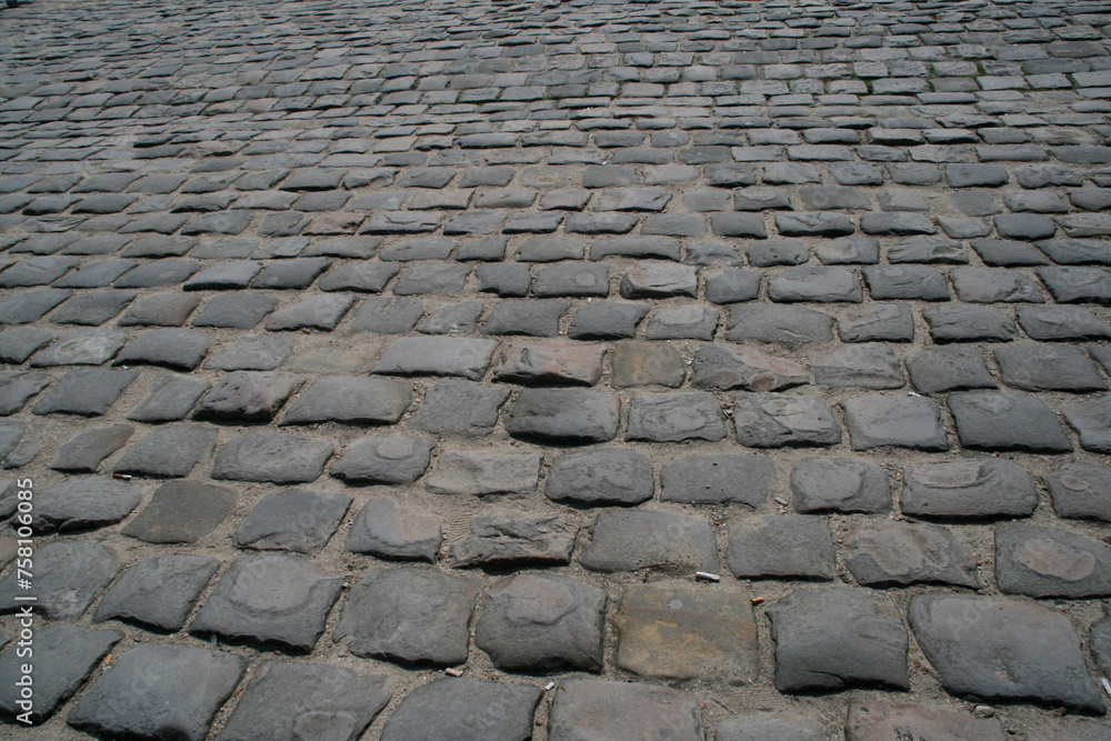 
Cobblestone street texture. Antique rectangular paving stones. Path paved with stones and worn by its use. Road paved with cobblestones.