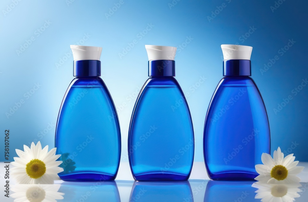 Blue bottles without inscriptions for shampoo on a black background with flowers in backlight with space for text Blue bottles without inscriptions for shampoo on a black background with flowers in backlight with space for text