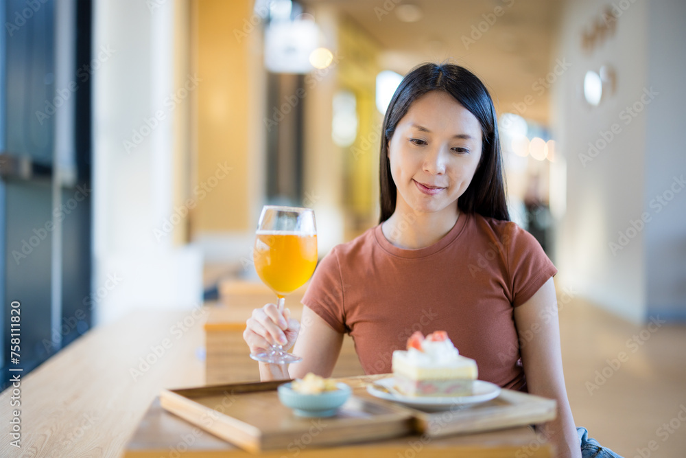 Woman enjoy her afternoon tea in coffee shop Woman enjoy her afternoon tea in coffee shop