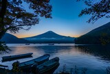 Mount Fuji at Dawn: Serene Lake View with Autumn Leaves, Boats, and Clear Blue Sky.