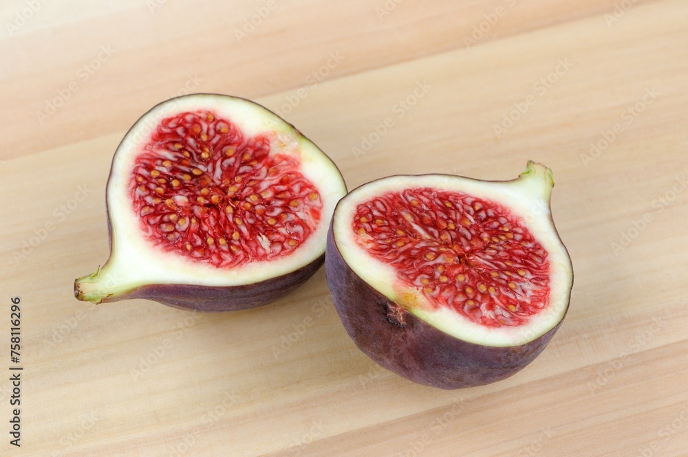 Fresh Fig Cut in Half on Wooden Background Fresh Fig Cut in Half on Wooden Background