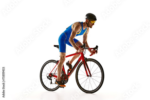 Athletic young man, cyclist in uniform, helmet and goggles in motion, riding bike isolated on white studio background. Concept of sport, active and healthy lifestyle, speed, endurance, hobby