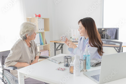 asian female doctor explaining about how to use medicine in hospital  elderly disease treatment  she holding drug strip pack with her hand