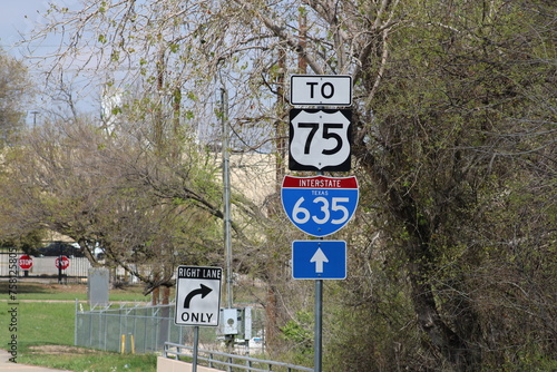 Farther down the street is a service road sign marking the main two routes of the Dallas High 5 interchange.  photo