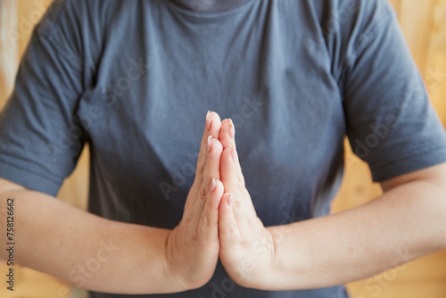 women’s hands in a prayer gesture, palm to palm, woman’s hands during meditation close-up. © Александр Ланевский