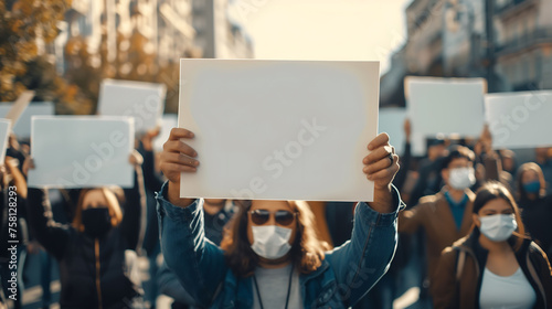 Close up of many people holding white blank paper for banner or sign at outdoor streets, protesters marching, street, white banner, copy space  photo