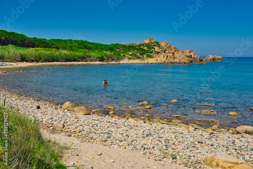two solitary bathers in the bay of Cala Cannedi in northern Sardinia (Italy) photo