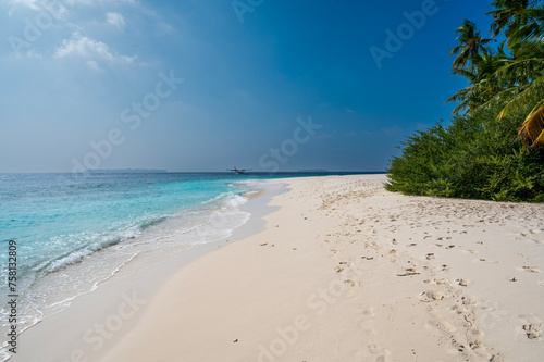 Nice sea coast with a sandy beach and a seaplane on the surface. © Denis