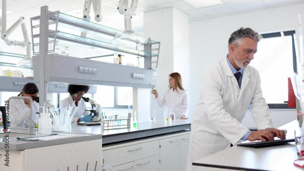 Mature scientist leading some lab investigation Mature scientist leading some lab investigation