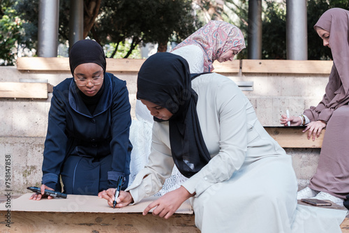 Two young people with hijab holding banners to go to a demonstration against the war