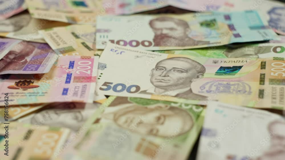 A stack of green banknotes, in various denominations, neatly arranged on a table. The cash represents different currencies, including dollars, portraying money handling and paper currency A stack of green banknotes, in various denominations, neatly arranged on a table. The cash represents different currencies, including dollars, portraying money handling and paper currency