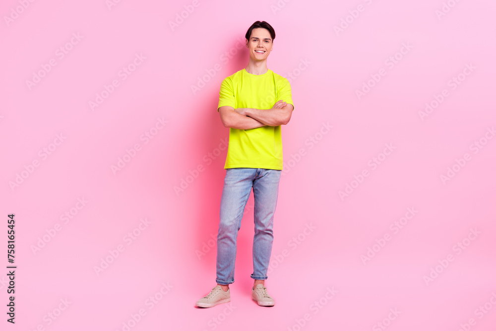 Full length photo of confident funky guy wear green t-shirt arms folded isolated pink color background Full length photo of confident funky guy wear green t-shirt arms folded isolated pink color background