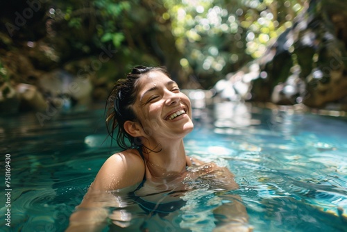 A woman with a gleeful grin  indulging in a refreshing swim in a secluded lagoon  the crystal-clear waters providing a welcome respite from the summer heat