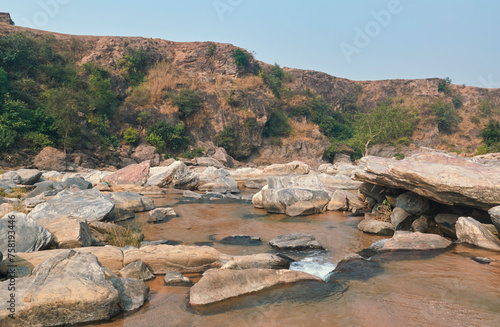 rustic nature landscape with primitive, rock formations in river bed of Telwa and nearby Dharara waterfalls in Simultala, Bihar. This landscape is part of Chota Nagpur Plateau. photo