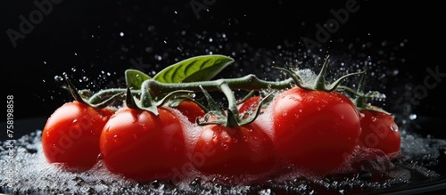 Vibrant Red Tomatoes Sprinkled with Salt on a Stylish Black Background