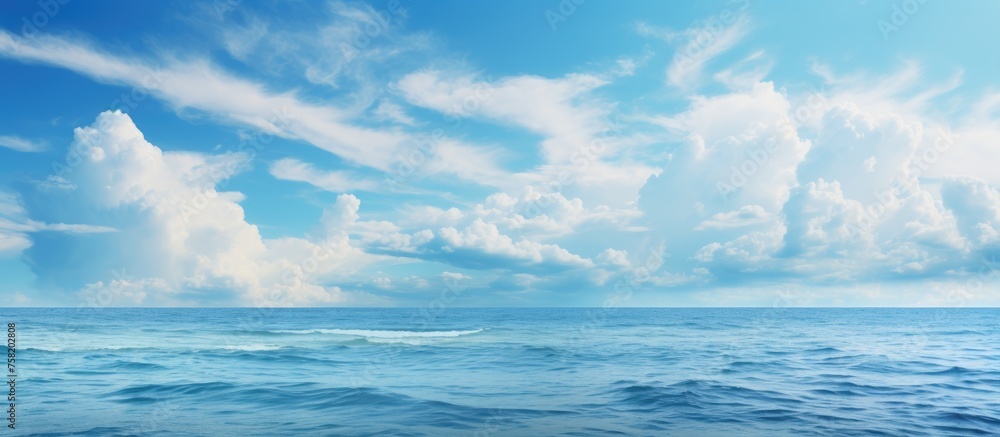 Tranquil Horizon: Majestic Blue Ocean with Wispy Clouds Offering Serenity and Reflection