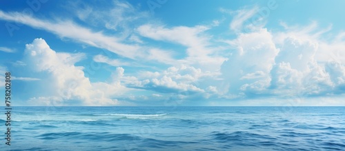 Tranquil Horizon: Majestic Blue Ocean with Wispy Clouds Offering Serenity and Reflection
