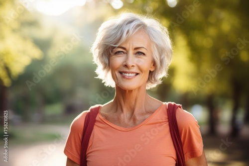 A woman with a backpack smiling at the camera. Suitable for travel and adventure themes