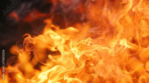  close-up of a raging fire with orange and red flames against a black background.