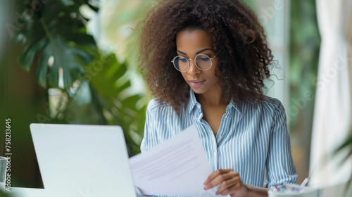 professional woman is sitting with a laptop
