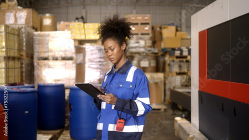 Female worker counting goods in warehouse