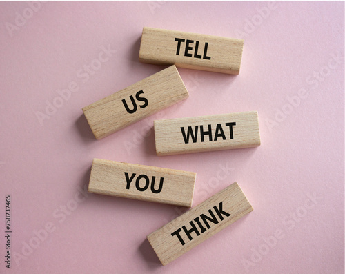 Tell us what you think symbol. Wooden blocks with words Tell us what you think. Beautiful pink background. Business and Tell us what you think concept. Copy space.