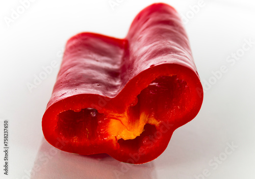 Cut of red bell pepper on white background
