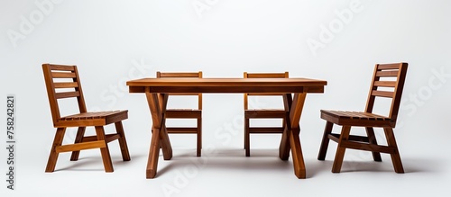 A hardwood table and chairs set, perfect for outdoor use. The rectangle table is stained with a wood varnish, complementing the natural wood finish