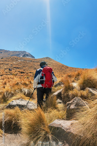 A man on his way to the top of the mountain. Copy space for text. photo